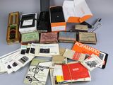 many different types of electronic devices and books on the table