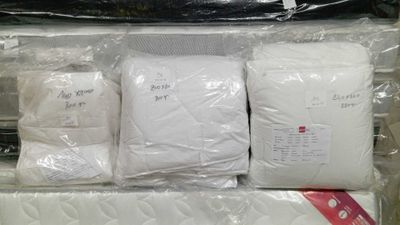 four bags of bedding and a pillow in a box
