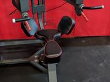 a machine that is sitting on the floor in front of a red wall