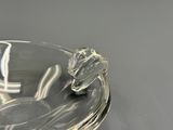 a glass ashtray with a silver lid on a table