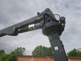 a crane that is attached to a brick wall