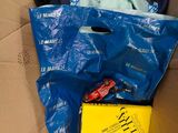 a box full of clothes and a book on the floor