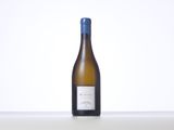 a bottle of white wine sitting on top of a table