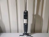 a vacuum that is sitting on a table next to some papers