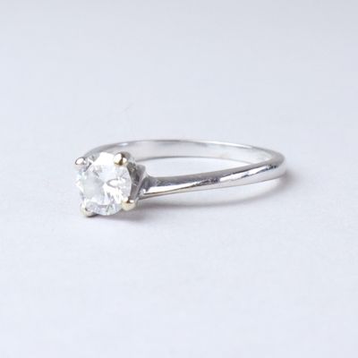 an image of a diamond ring on a white surface