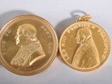 two gold coins with a picture of a man and a woman on them
