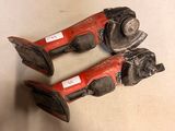 pair of old red and black pipe cutters on a white surface