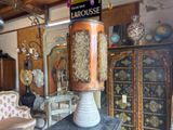 a tall vase sitting on top of a table in a room