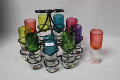 many different colored glasses and a wine glass on the table