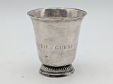 a silver cup with a handle and a handle on the rim