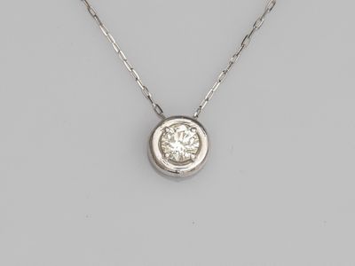 a diamond single - stone pendant on a chain