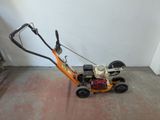 a small lawn mower that is sitting on the floor
