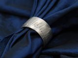 a close up of a napkin with a ring on top of it