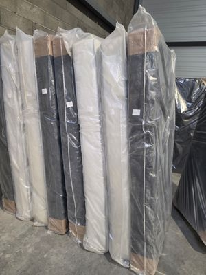 a lot of mattresses that are wrapped up and ready to be shipped