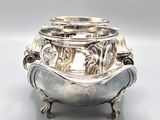 an image of a silver bowl with elephants on it on a white surface