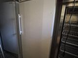 a white refrigerator in the corner of a kitchen next to a shelf