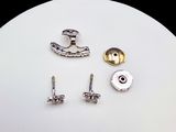 four different types of screws on a white plate
