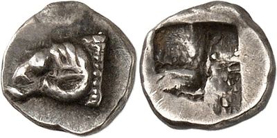 a close up of a silver coin with a cat on it