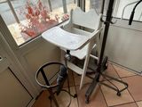 a baby high chair in the corner of the room