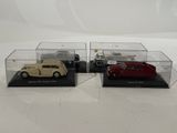 three model cars in display cases on a white surface