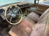 dashboard of an old car with a steering wheel and dashboard buttons