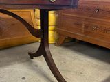 a wooden table with a drawer on it in a room