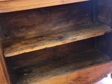 a wooden shelf that has a wooden shelf on top of it