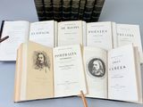 several open books sitting on top of a table next to a cup of coffee