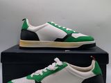 a pair of green and white sneakers sitting on top of a box