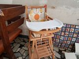 a baby high chair in the corner of a room