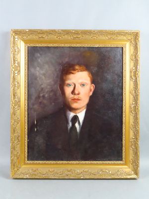 portrait of a young man in a suit and tie in a gold frame