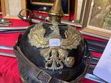 a helmet with a gold eagle on it sitting on a table