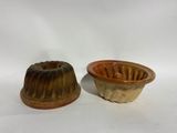 pair of ceramic molds of a bundt cake and a cupcake mold