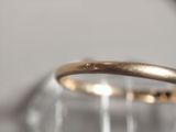 a close up of a gold ring with a diamond on it