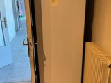 a white refrigerator sitting in the corner of a room