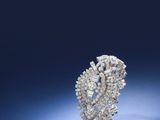 a close up of a diamond ring on a blue surface