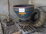 a blue bucket sitting on top of a pallet next to a pile of dirt