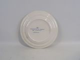 a white plate with blue writing on it on a white surface