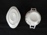 pair of porcelain bowls and saucers on a black background