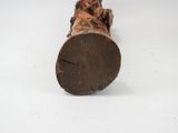 a small statue of a man sitting on a log