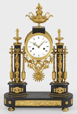 a black and gold clock sitting on top of a table