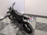 a motorcycle that is sitting on a checkered floor