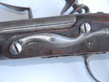 a close up of a gun on a white surface