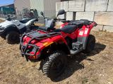 two atvs parked next to each other on the grass