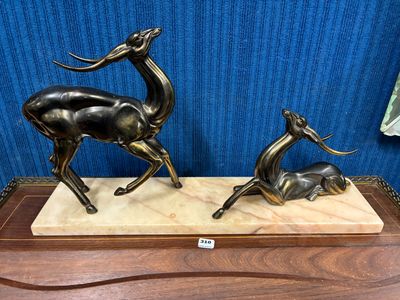 paire de statues de cerfs en bronze posées sur un socle en marbre, le tout monté sur un support en bois