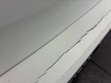 a crack in the side of a white car