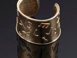 un gros plan d'une bague en or ornée d'un motif
