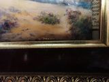 a picture of a painting of a beach scene in a gold frame