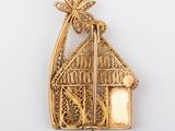an image of a gold plated brooch with a bird in a cage
