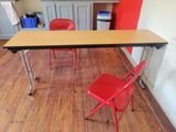a red chair sitting at a table in a kitchen